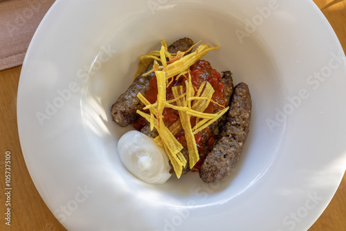 Obraz na płótnie Mirada meatballs, grated and cooked potatoes, served with tomato sauce. w salonie