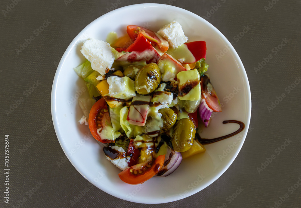 Greek salad with 3 California peppers, cherry tomatoes, endive lettuce, feta cheese, green olives, red onion, grissini and sauce.