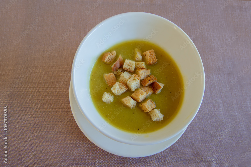 Lentil soup garnished with crispy bread.