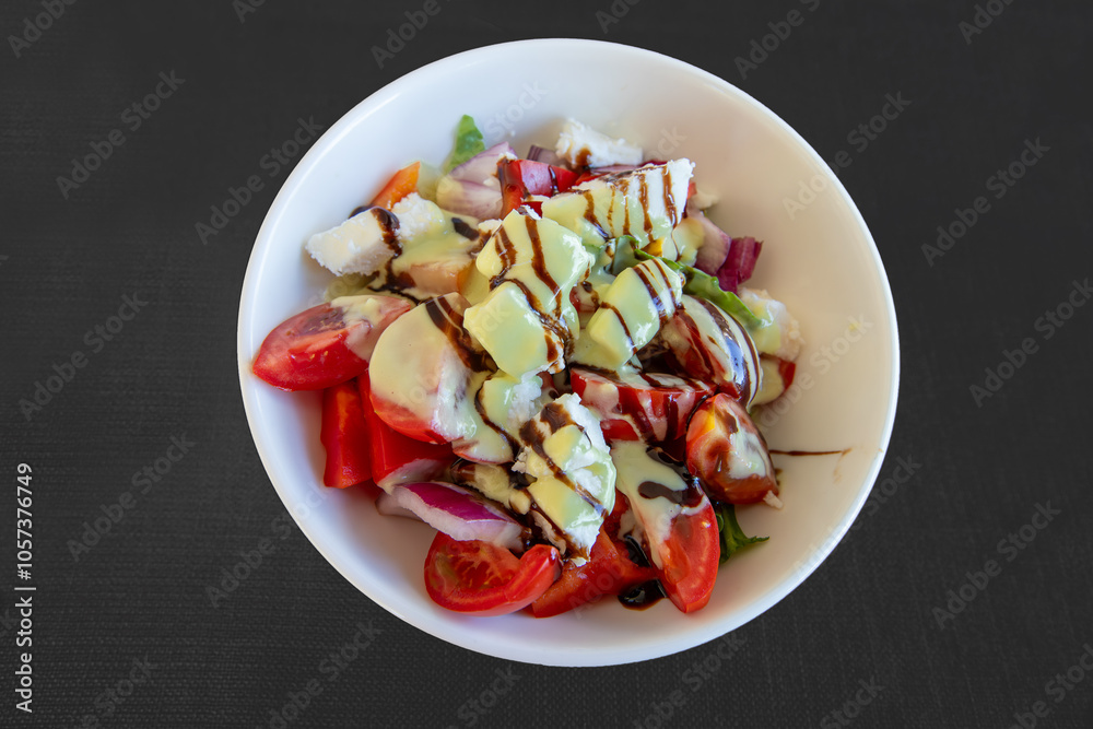 Greek salad with 3 California peppers, cherry tomatoes, endive lettuce, feta cheese, green olives, red onion, grissini and sauce.