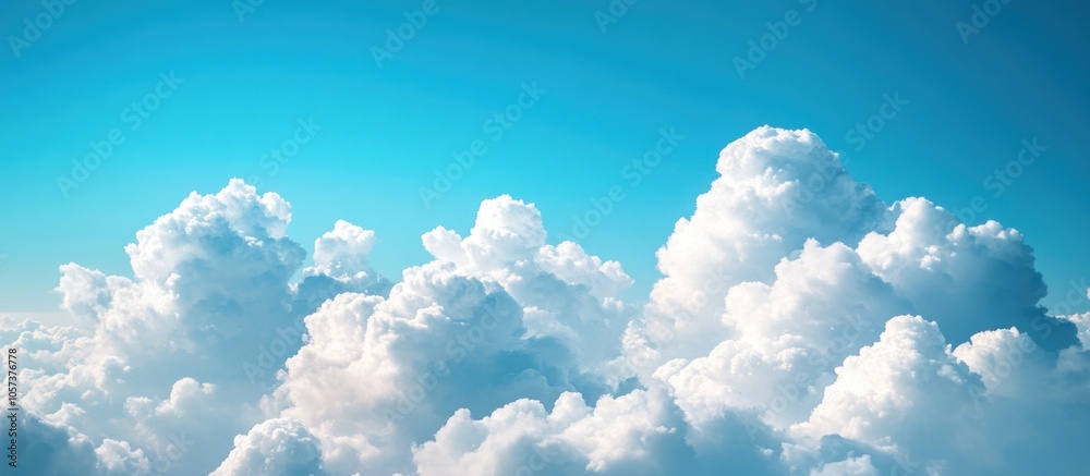 Fluffy white clouds against a bright blue sky. Fluffy white clouds against a bright blue sky.