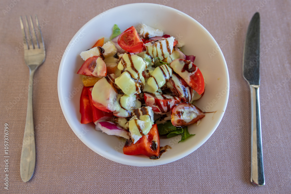 Greek salad with 3 California peppers, cherry tomatoes, endive lettuce, feta cheese, green olives, red onion, grissini and sauce.