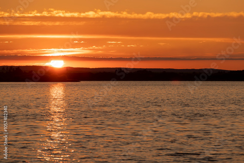 beautiful sunset with sun and orange sky on the lake
