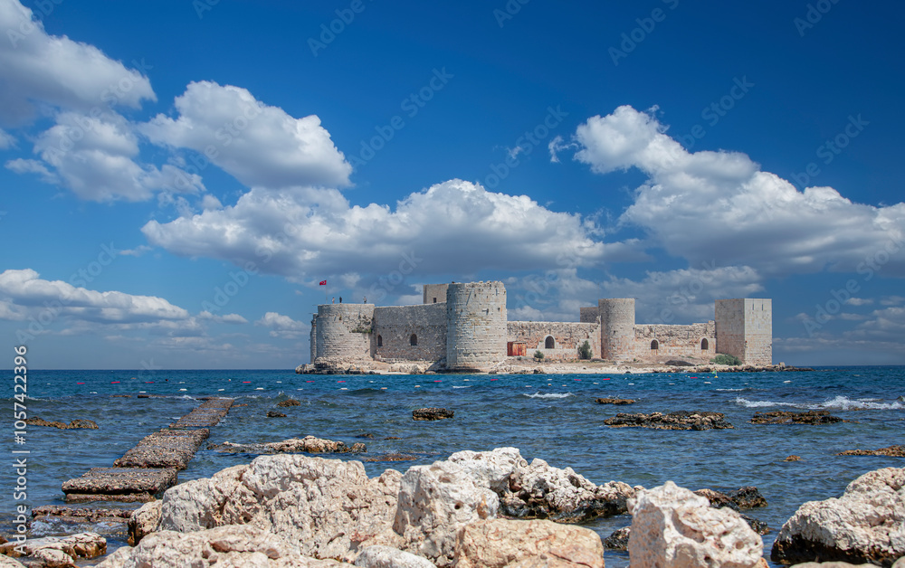 Cloudy sky and Maiden Castle (Kız Kalesi) and rocky field - Mersin, Türkiye.