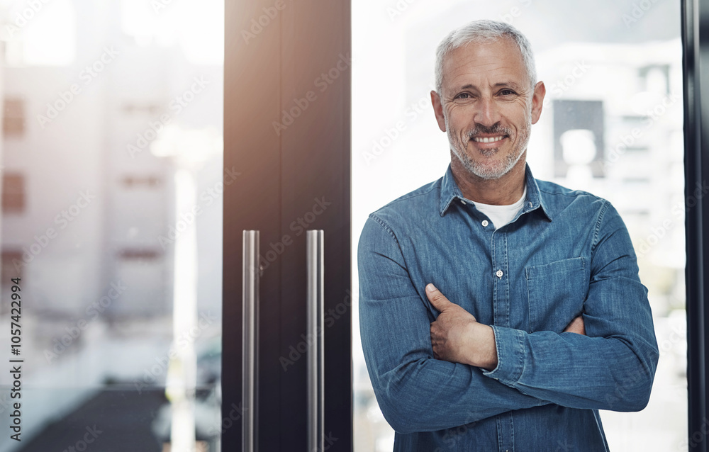 Mature, portrait and businessman with confidence by window at office for job or career startup. Male person, happy designer or creative employee with smile or arms crossed for professional expertise Mature, portrait and businessman with confidence by window at office for job or career startup. Male person, happy designer or creative employee with smile or arms crossed for professional expertise