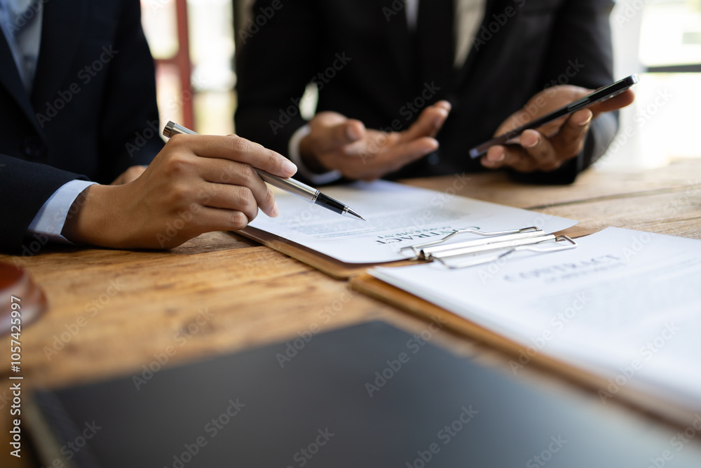 Lawyer is giving legal advice to a businessman in the legal counsel's office. Meeting with the legal team to discuss the contract agreement and its signing. Lawyer is giving legal advice to a businessman in the legal counsel's office. Meeting with the legal team to discuss the contract agreement and its signing.