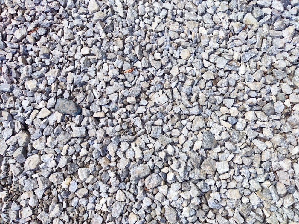 Gray gravel spread across a construction site on a sunny day Gray gravel spread across a construction site on a sunny day