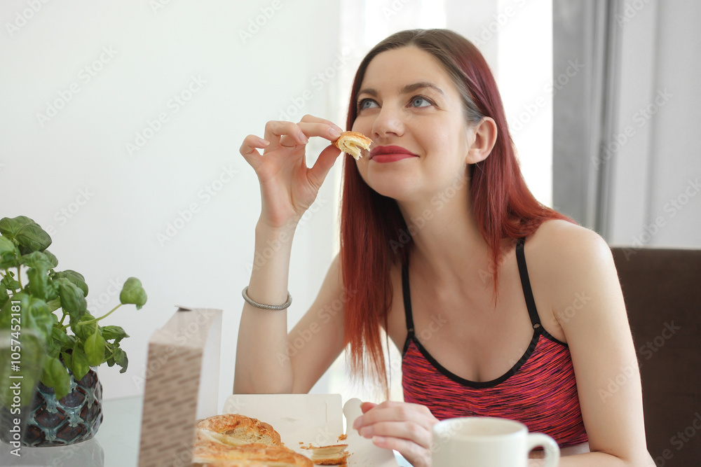 happy woman having breakfast in the kitchen happy woman having breakfast in the kitchen
