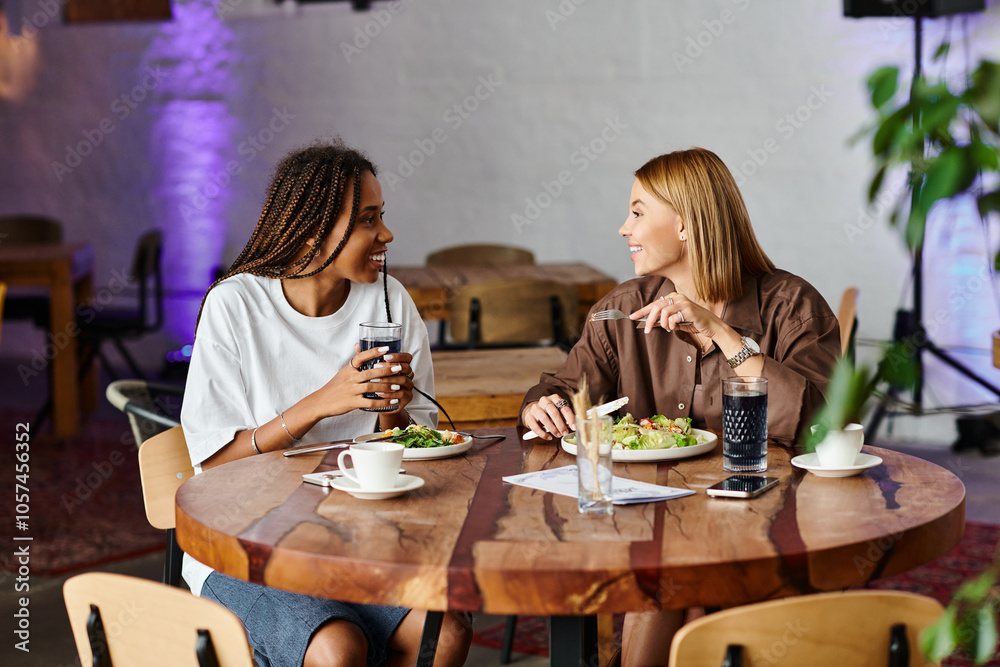 A joyful couple enjoys each other's company at a cozy cafe, sharing food and laughter while sipping drinks. A joyful couple enjoys each other's company at a cozy cafe, sharing food and laughter while sipping drinks.