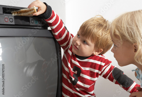 Boy Putting Sandwich in VCR photo