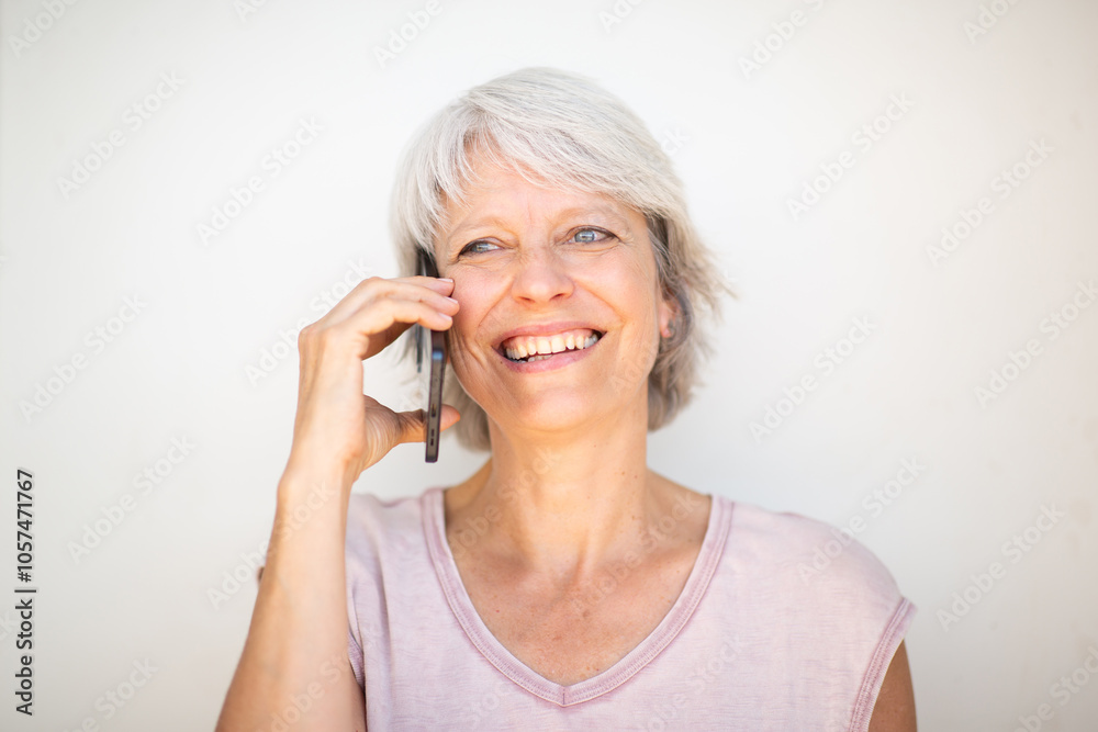 Woman smiling while having a phone conversation Woman smiling while having a phone conversation