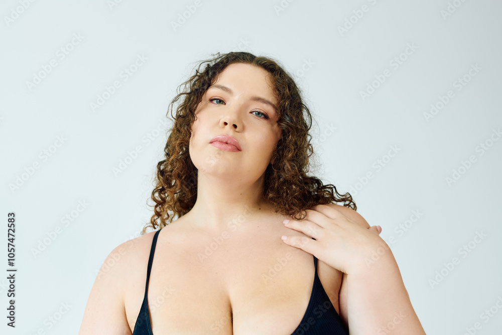 A stunning plus size woman poses gracefully, embracing her curves and self love. A stunning plus size woman poses gracefully, embracing her curves and self love.