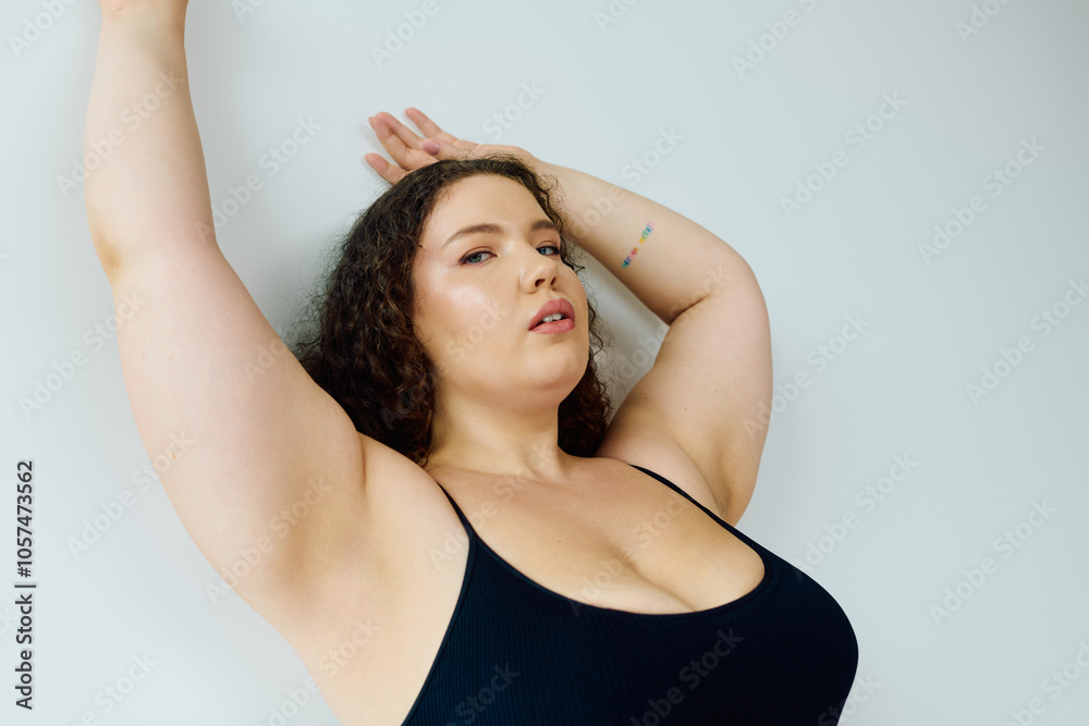 A stunning plus size woman poses gracefully, showcasing her confidence and beauty. A stunning plus size woman poses gracefully, showcasing her confidence and beauty.