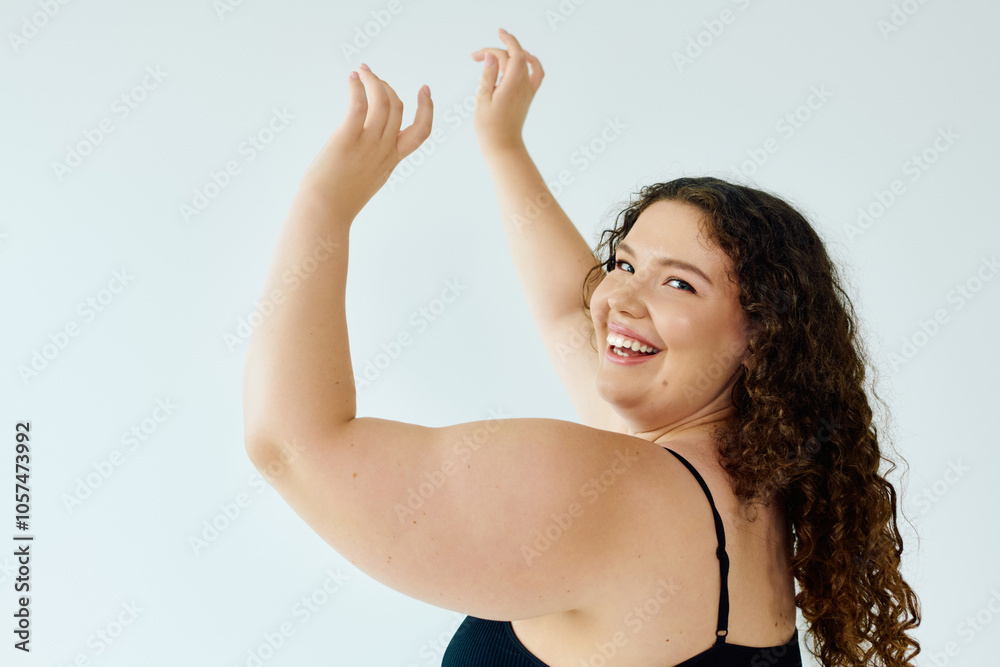 A joyful plus size woman embraces her beauty, radiating confidence in a bright studio. A joyful plus size woman embraces her beauty, radiating confidence in a bright studio.