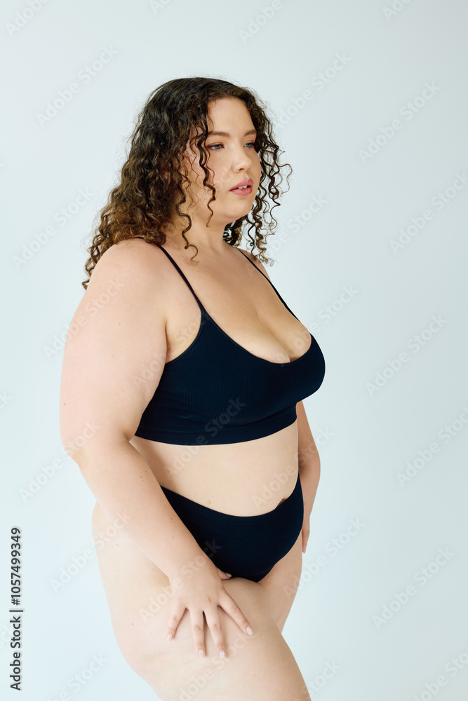 A confident plus size woman models chic black lingerie, radiating beauty and self love. A confident plus size woman models chic black lingerie, radiating beauty and self love.