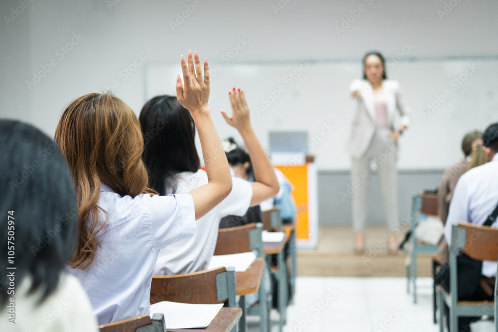 Students Raising Hands in Classroom with Teacher Presenting Students Raising Hands in Classroom with Teacher Presenting