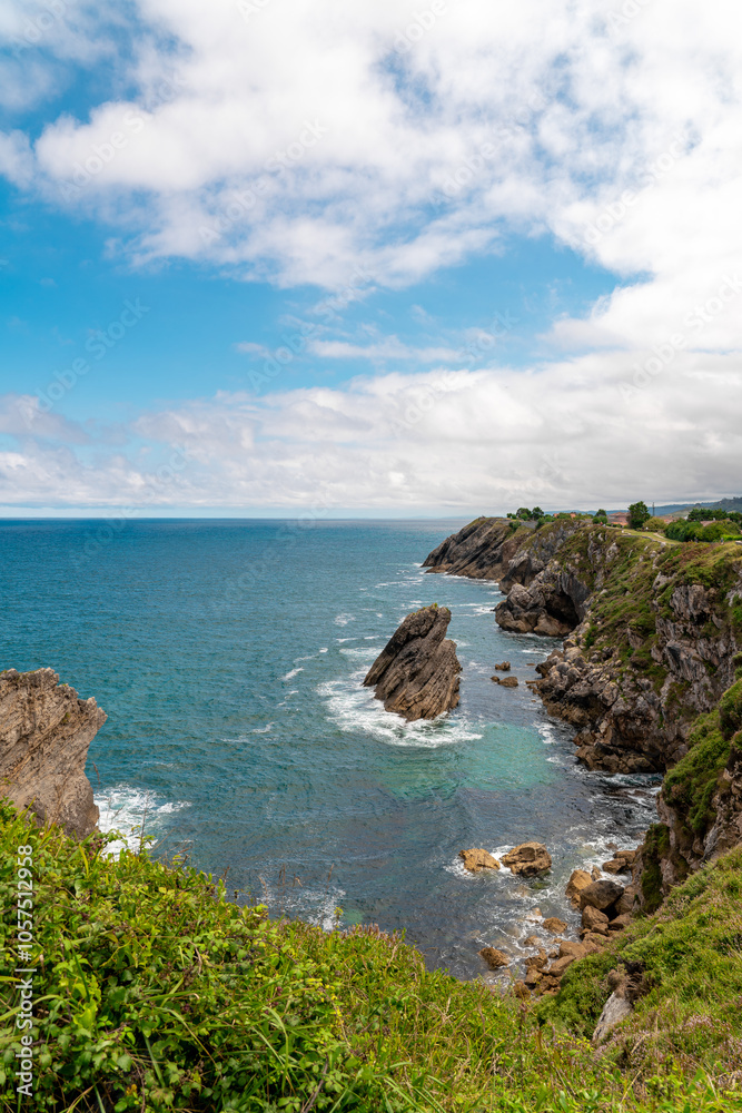Spectacular natural lanscape in north of Spain, Asturias. Green coastline of Spain. High cliff. Turquoise water. Waves breaking on the rock. Famous travel destination. Spectacular natural lanscape in north of Spain, Asturias. Green coastline of Spain. High cliff. Turquoise water. Waves breaking on the rock. Famous travel destination.