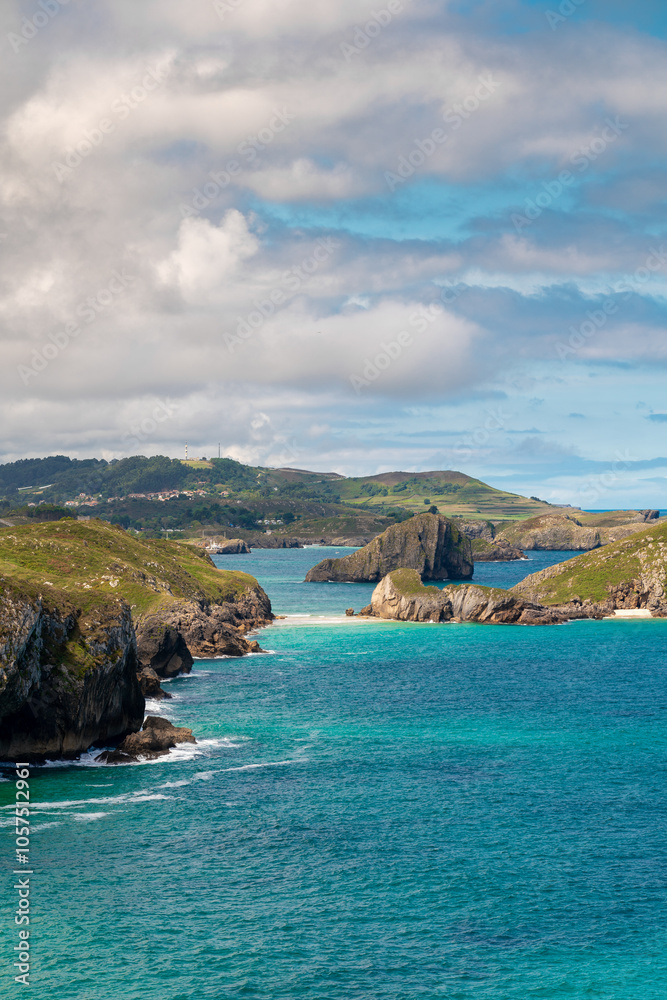 Spectacular natural lanscape in north of Spain, Asturias. Green coastline of Spain. High cliff. Turquoise water. Waves breaking on the rock. Famous travel destination. Spectacular natural lanscape in north of Spain, Asturias. Green coastline of Spain. High cliff. Turquoise water. Waves breaking on the rock. Famous travel destination.