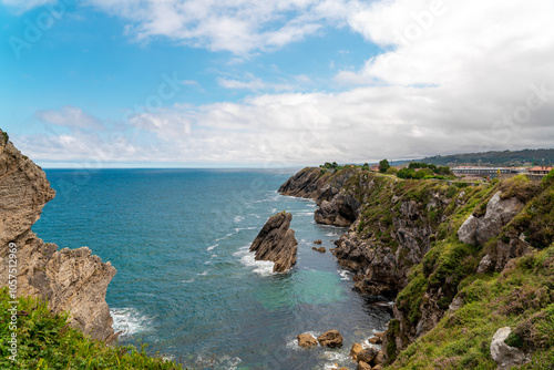 Spectacular natural lanscape in north of Spain, Asturias. Green coastline of Spain. High cliff. Turquoise water.  Waves breaking on the rock. Famous travel destination. 