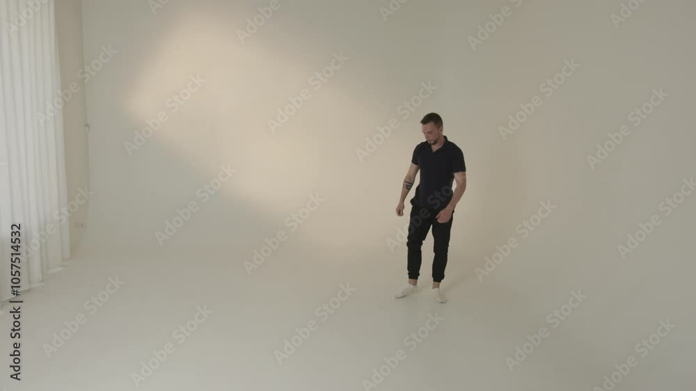 A dancer performs gracefully in a minimalist studio, embodying an artistic expression A dancer performs gracefully in a minimalist studio, embodying an artistic expression