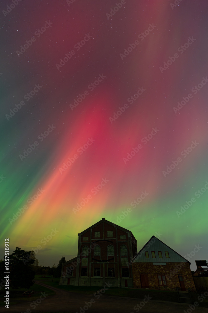 Brilliant Northern Lights over Old Industrial Buildings