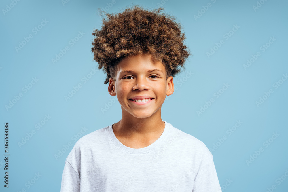 Portrait of handsome, attractive African American boy with curly hair wearing white t shirt Portrait of handsome, attractive African American boy with curly hair wearing white t shirt