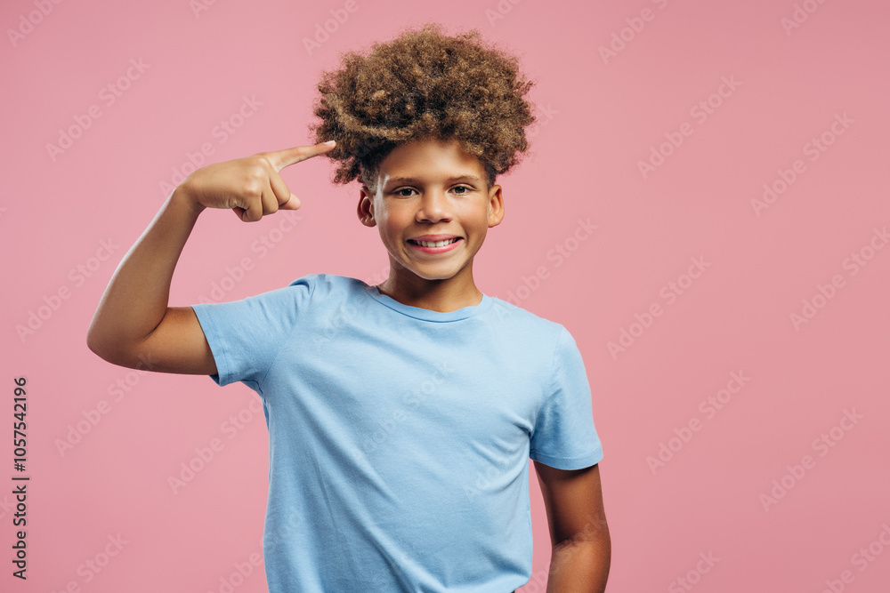 Strong, smiling, happy African American boy, teenager having curly hair, showing biceps on hands Strong, smiling, happy African American boy, teenager having curly hair, showing biceps on hands