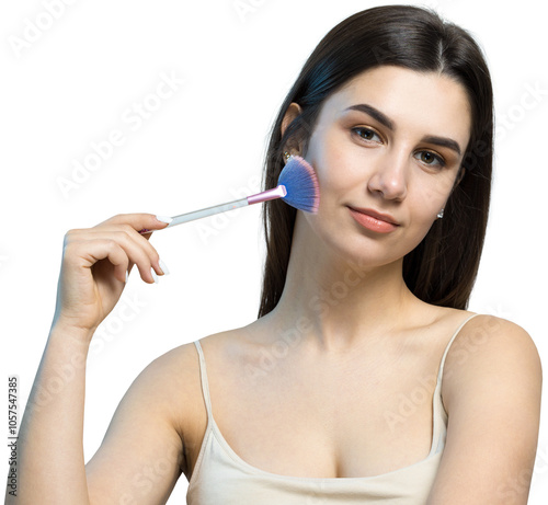 Close-up of a young girl in a light top on a white background making a facial make-up. A pretty woman holds a cosmetic brush near her face and smiles.