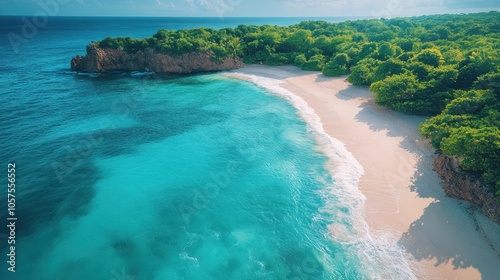 An aerial view of a pristine tropical beach with white sand, turquoise water, and lush green vegetation.