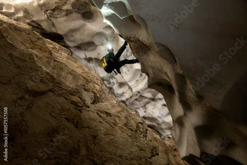 Caver rappelling in the ice caves of the European Alps, threatened by global warming photo