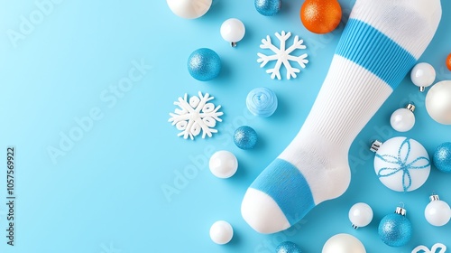 Snowflakepatterned socks in soft blues and whites, lying next to holiday decorations photo