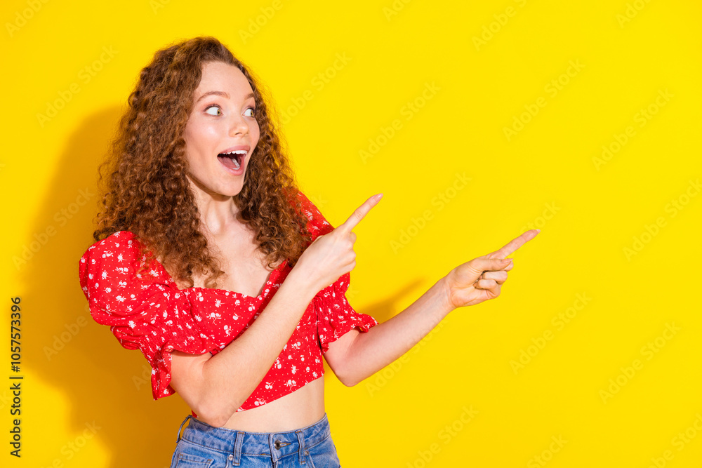 Photo portrait of lovely young lady look point empty space dressed stylish red garment isolated on yellow color background Photo portrait of lovely young lady look point empty space dressed stylish red garment isolated on yellow color background