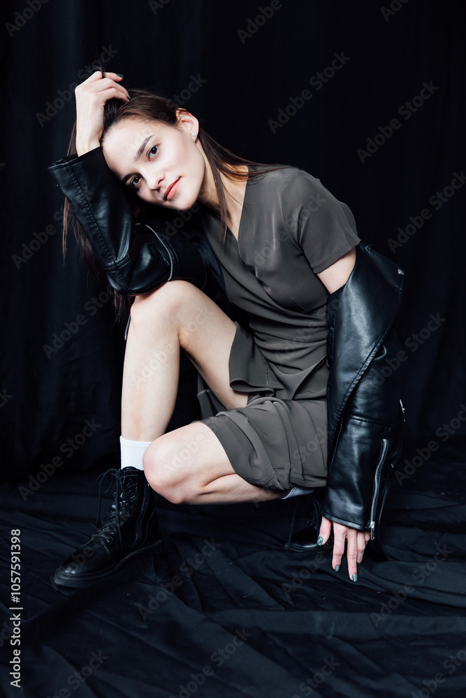 Beautiful fashionable woman in gray summer dress and black jacket Beautiful fashionable woman in gray summer dress and black jacket