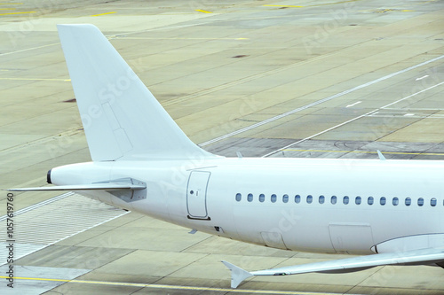 Tail fin and fuselage of an unmarked holiday jet. No people. photo