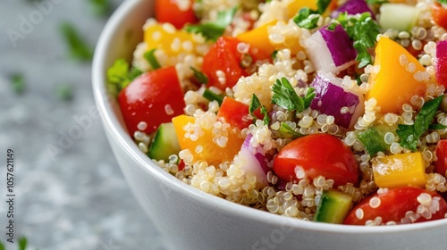 Close up of a quinoa salad featuring vibrant fresh vegetables in a white bowl