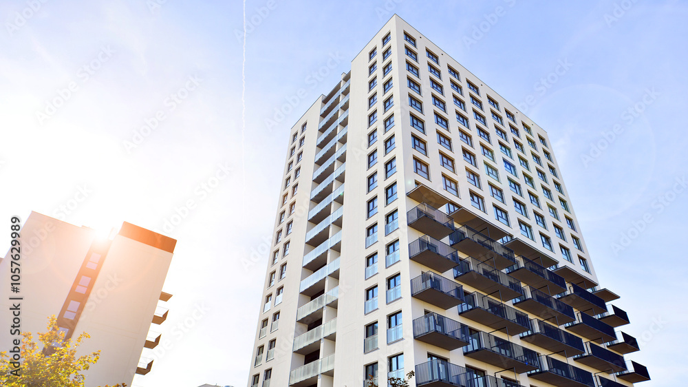 Modern high-rise apartment building in white, stand tall against a blue sky, exemplifying innovative urban architecture with sleek, angular designs. Modern high-rise apartment building in white, stand tall against a blue sky, exemplifying innovative urban architecture with sleek, angular designs.