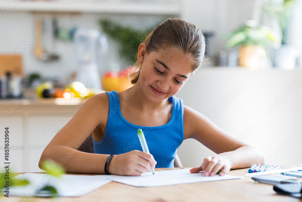 Little kind girl drawing in the kitchen at home Little kind girl drawing in the kitchen at home