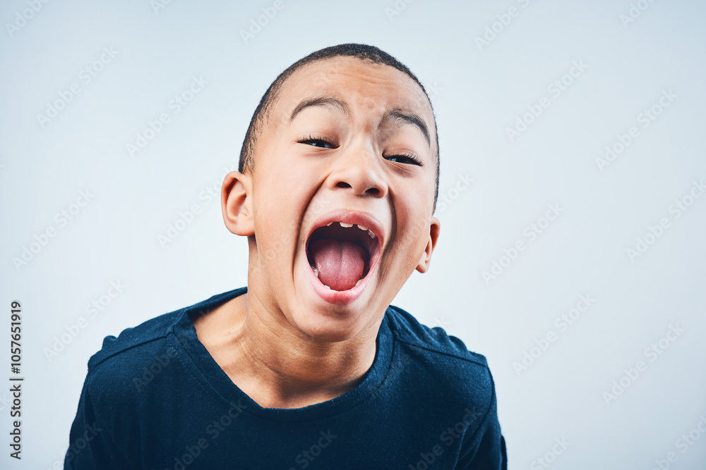 Shout, scream and portrait of kid in studio with anger, upset and mad reaction on white background. Frustrated, facial expression and isolated young boy with behavior, unhappy and bad attitude Shout, scream and portrait of kid in studio with anger, upset and mad reaction on white background. Frustrated, facial expression and isolated young boy with behavior, unhappy and bad attitude