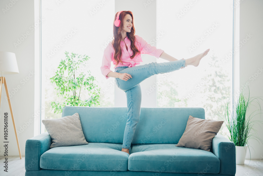 Full length portrait of nice young girl rejoice dance sofa modern white interior flat indoors Full length portrait of nice young girl rejoice dance sofa modern white interior flat indoors