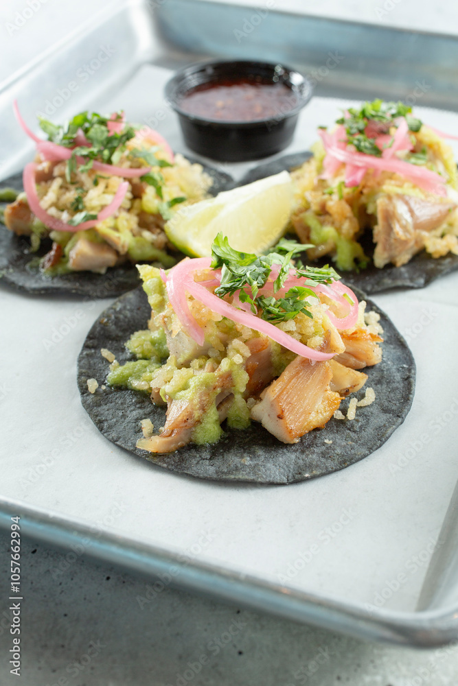 A view of some street tacos on a tray.