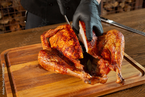 A view of a chef cutting through a roasted turkey. photo