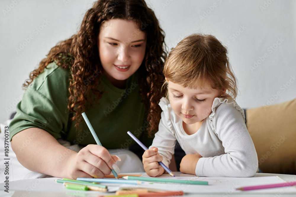 A mother and daughter enjoy art together, coloring and sharing moments of laughter and creativity. A mother and daughter enjoy art together, coloring and sharing moments of laughter and creativity.