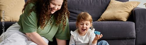 A mother and daughter share a joyful afternoon of laughter and play in their cozy living room. photo