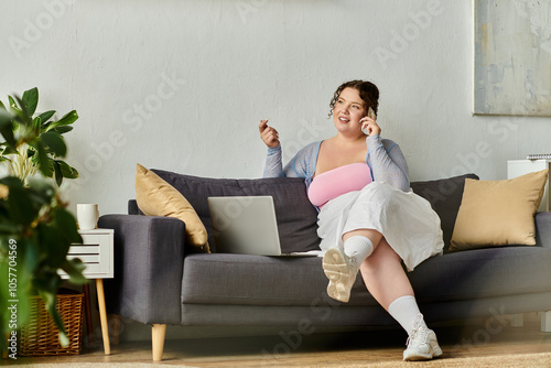 Talkative young woman in cozy homewear enjoys a relaxed day at home. photo