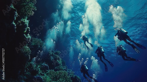 Scuba Divers Descending Into Vibrant Coral Reef