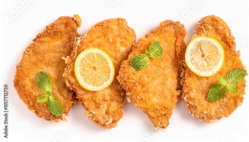 Breaded chicken breast cutlets with lemon and mint on white background