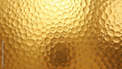 Textured golden surface with raised bubble patterns, copy space