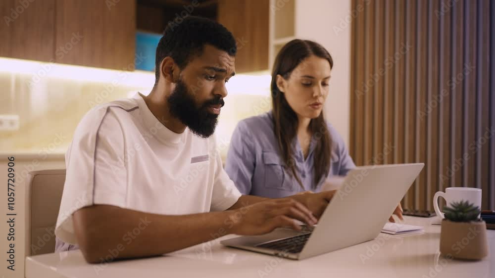 Multiracial couple applying for a visa online on laptop, receiving bad news Multiracial couple applying for a visa online on laptop, receiving bad news