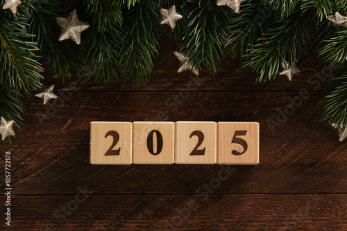 New Year 2025 wooden blocks with Christmas decorations fir branches and gold stars