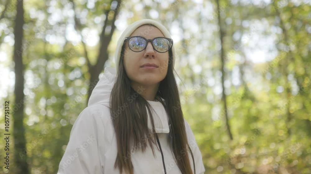 Relaxing in nature woman with glasses and white jacket in autumn woods Relaxing in nature woman with glasses and white jacket in autumn woods
